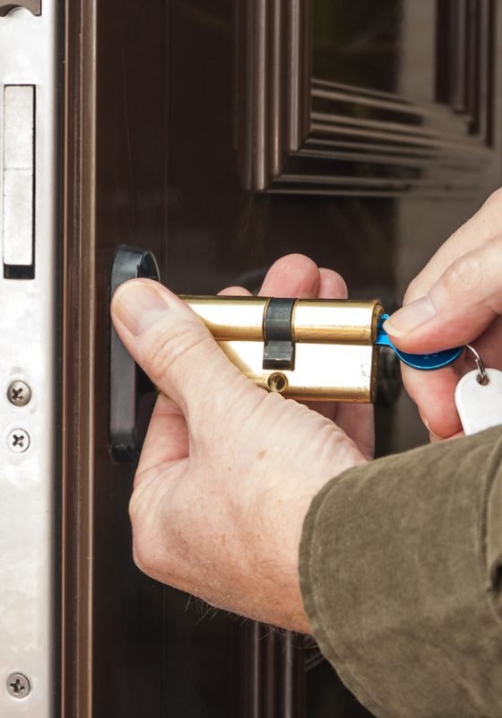 Locksmith replacing a cylinder lock